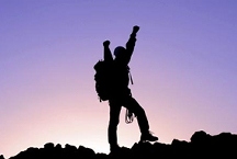 Hiker/climber with arms up in victory